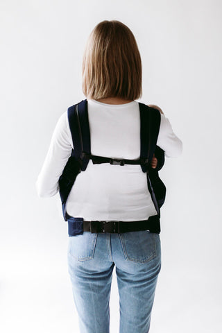 Woman carrying twins in Weego TWIN, back view